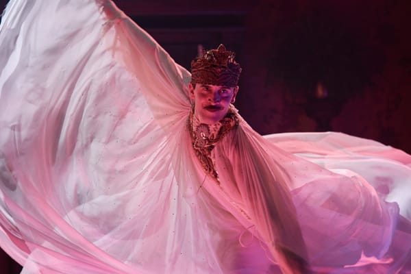 A still from the film Madfabulous, depicting the main character Henry Paget in a fancy costume, performing a dance.