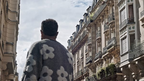 One of the actors representing the Palestinian interviewees looks down a Parisian street towards the sky.
